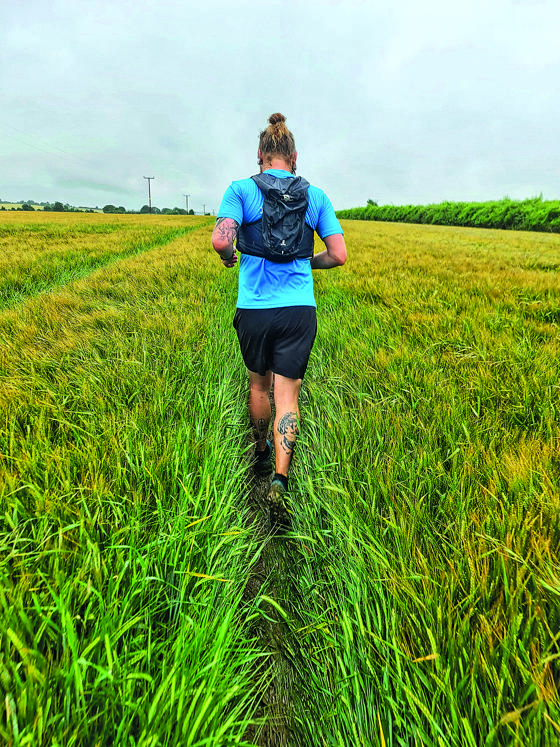 Man Running In A Field With Back To Camera
