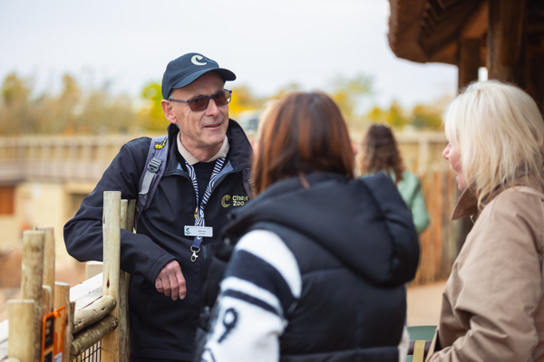 A volunteer at Chester Zoo talking to visitors