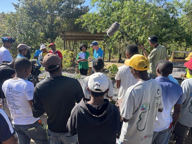 A photo showing nursery workers and horticulturalists gathered in an open space to teach each other skills