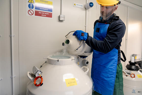 Image shows John, a Chester Zoo scientist, topping up a cryo tank with liquid nitrogen